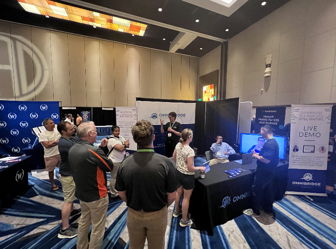Conference attendees watching Adam demo OmniBridge's alpha product at NAD 2022