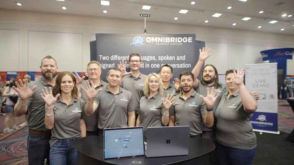 OmniBridge team members waving from the OmniBridge booth at Deaf Nation 2022